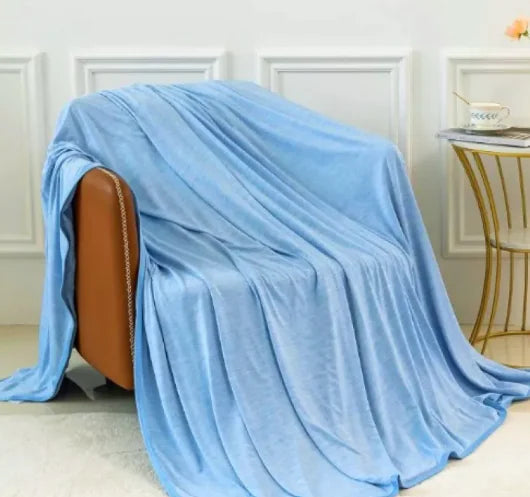 Blue cooling blanket draped on chair